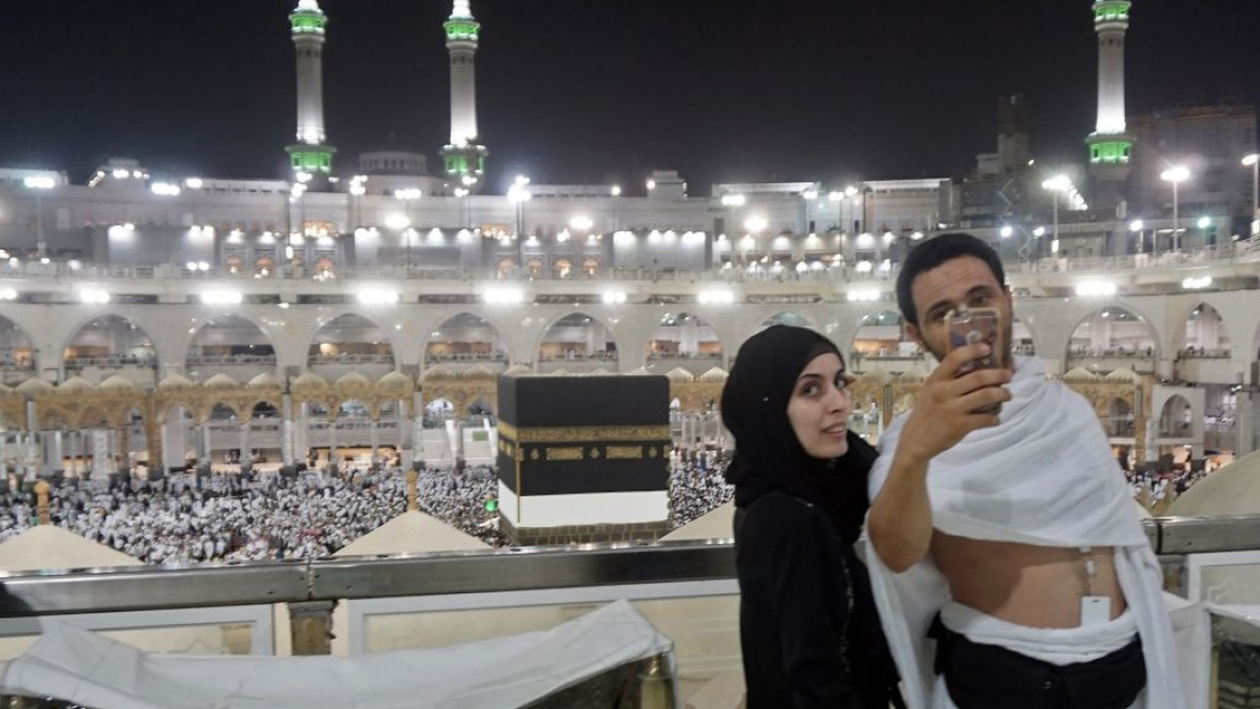 A couple taking a selfie while on hajj at Mecca's Great Mosque