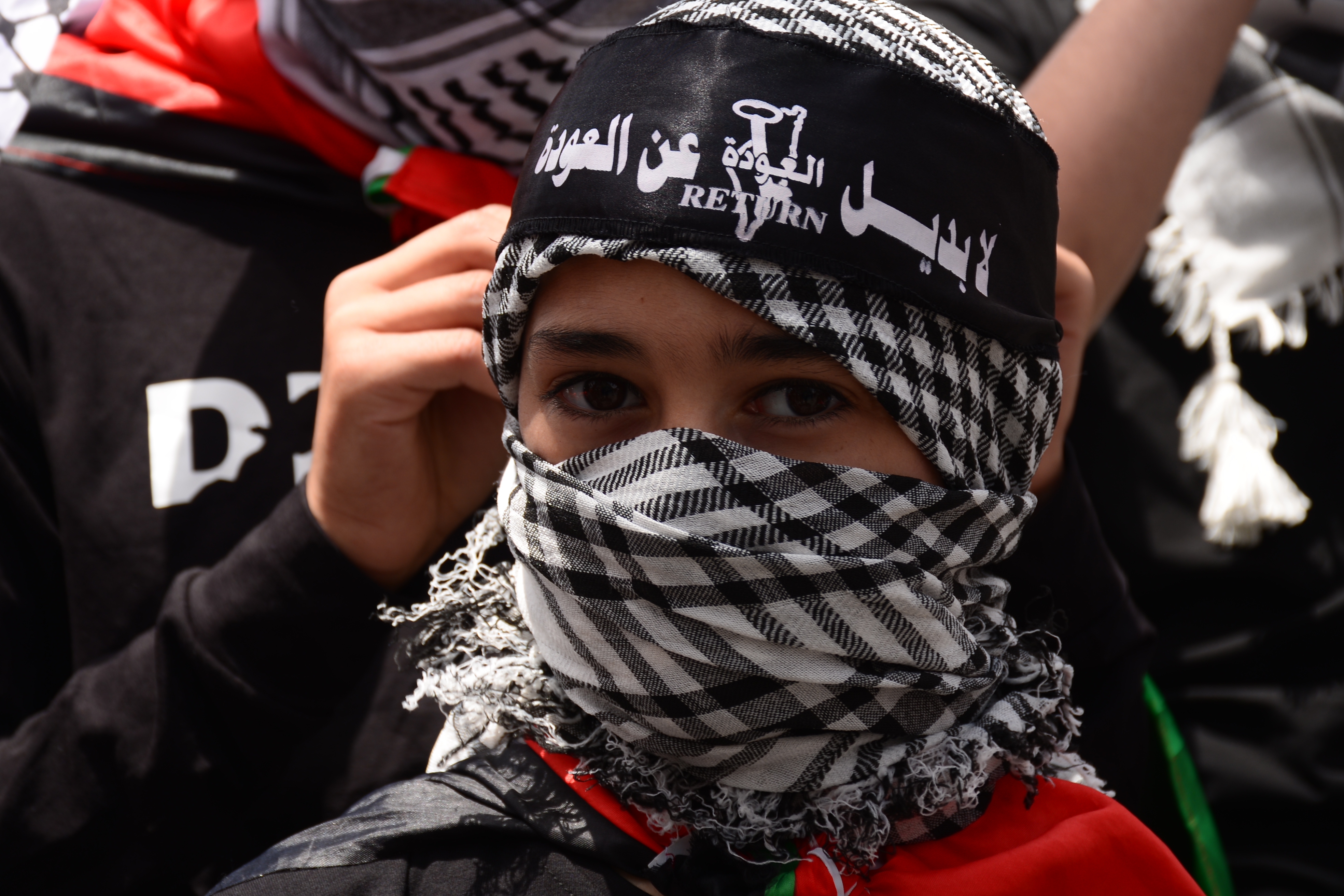 Young man with Palestinian keffiyeh feeling inner world, Stock