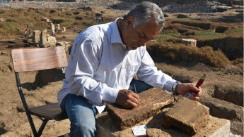 Archaeologist working on a block of limestone