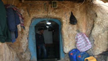 Yousef stands near the entrance of his cave.