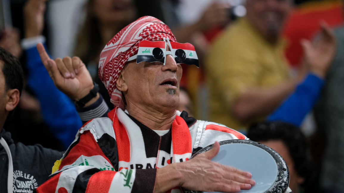 A man dressed in Iraqi flags at football's 2019 Gulf Cup