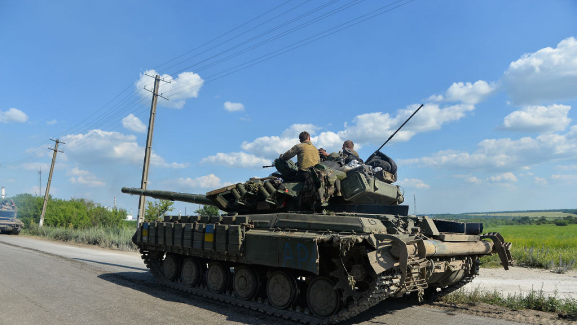 A tank with a Ukrainian flag on the side.