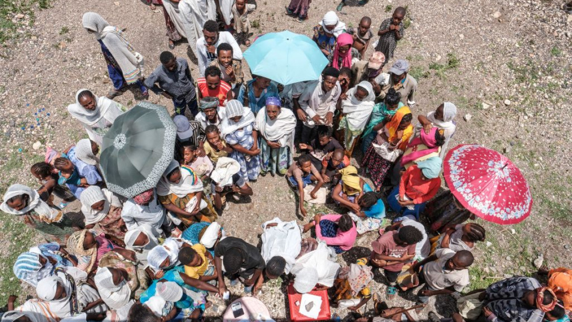 People wait to register during a food distribution organized by the Amhara government near the village of Baker, 50 kms South East of Humera, in the northern Tigray Region on July 11, 2021. 