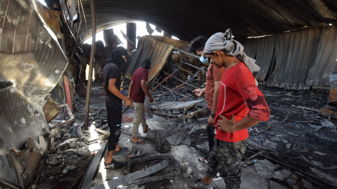 NASIRIYA, IRAQ - JULY 15: Residents inspect the damage after the deadly fire that engulfed the coronavirus isolation ward at Al-Hussein Hospital in Nasiriya city in Dhi Qar governorate, Iraq on July 15, 2021. (Photo by Arshad Mohammed/Anadolu Agency via Getty Images)