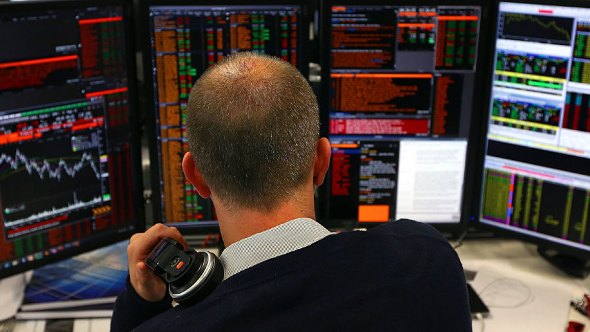 A trader looking at stock market information screens
