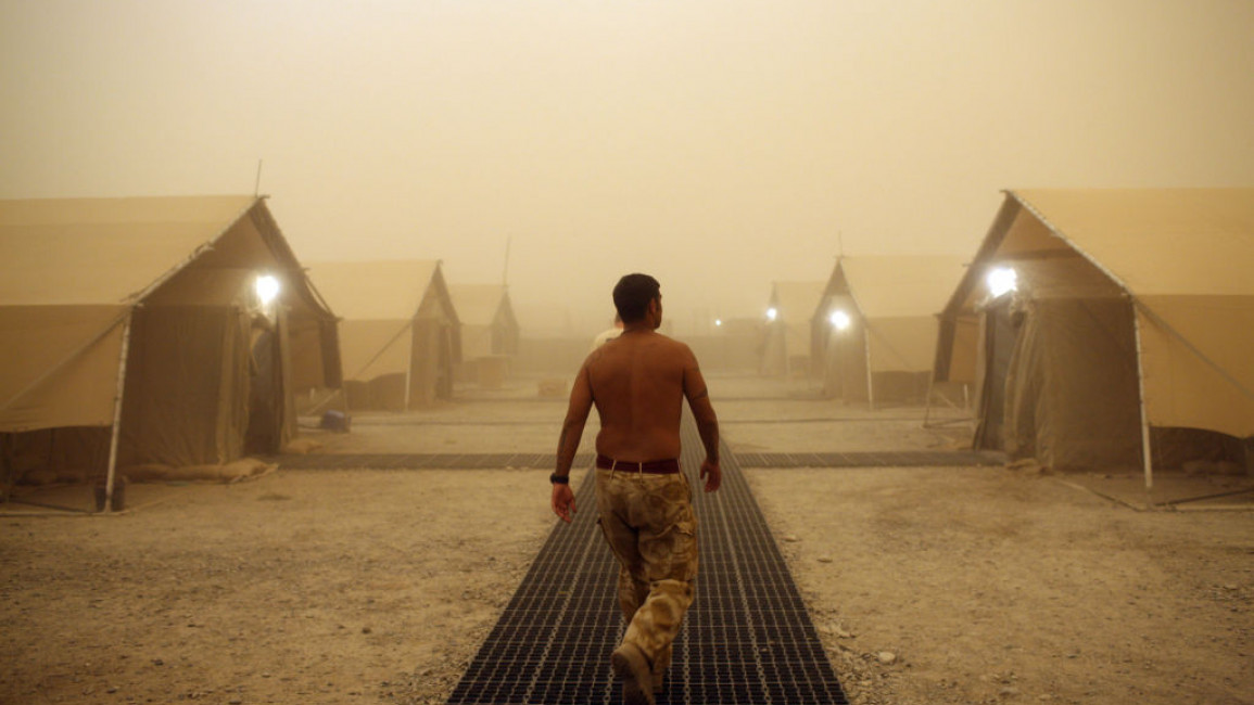 A British Army soldier from the 3rd Battalion The Parachute Regiment walks during a sand storm as he prepare to leave for strike operation Southern Beast on August 2, 2008. [Getty]