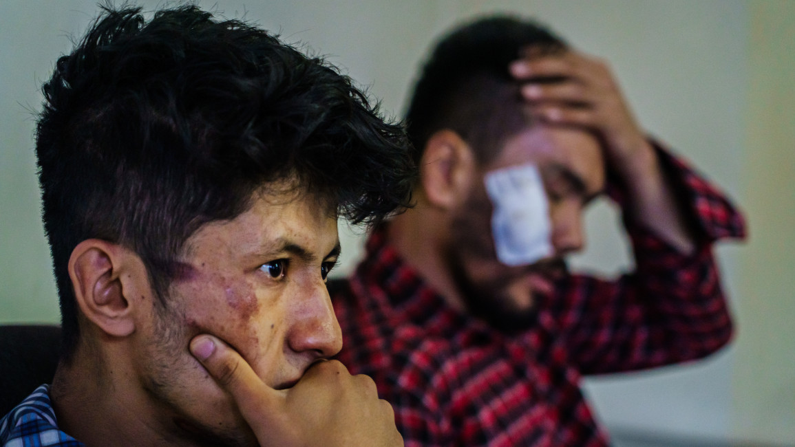 Nemat Naqdi, right, was beaten by Taliban forces [Getty]
