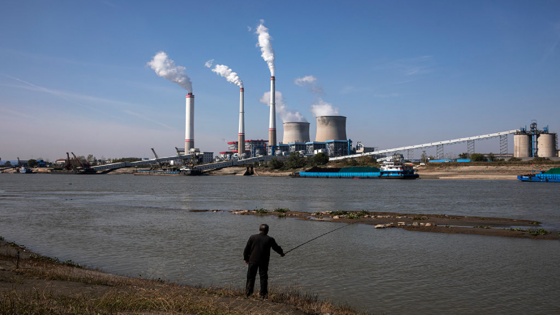 Residents are fishing as coal fired power plant is in operation in China