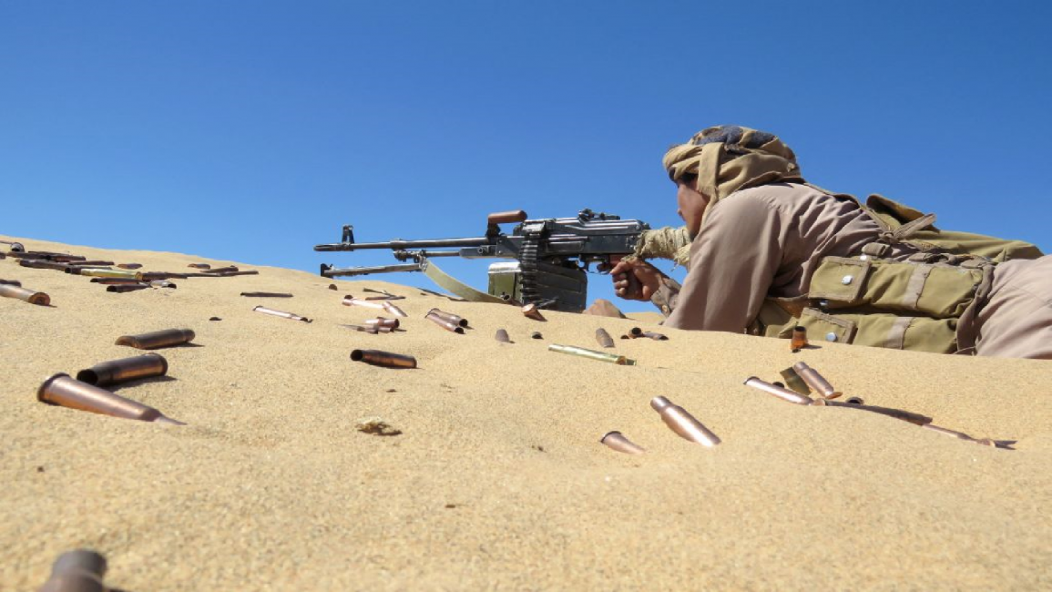 A Yemeni pro-government fighter takes aim from his position during fighting with Houthi rebels
