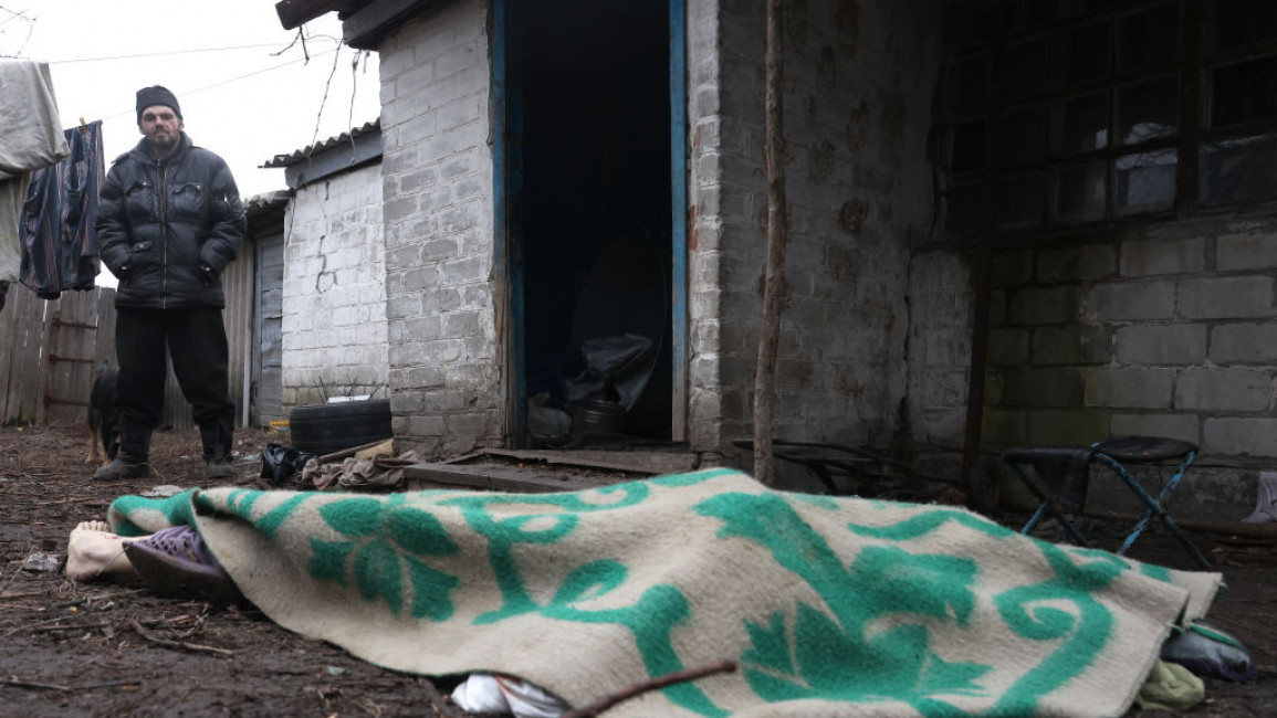 A blanket covers the body of a woman killed by shellfire in Gorlovka