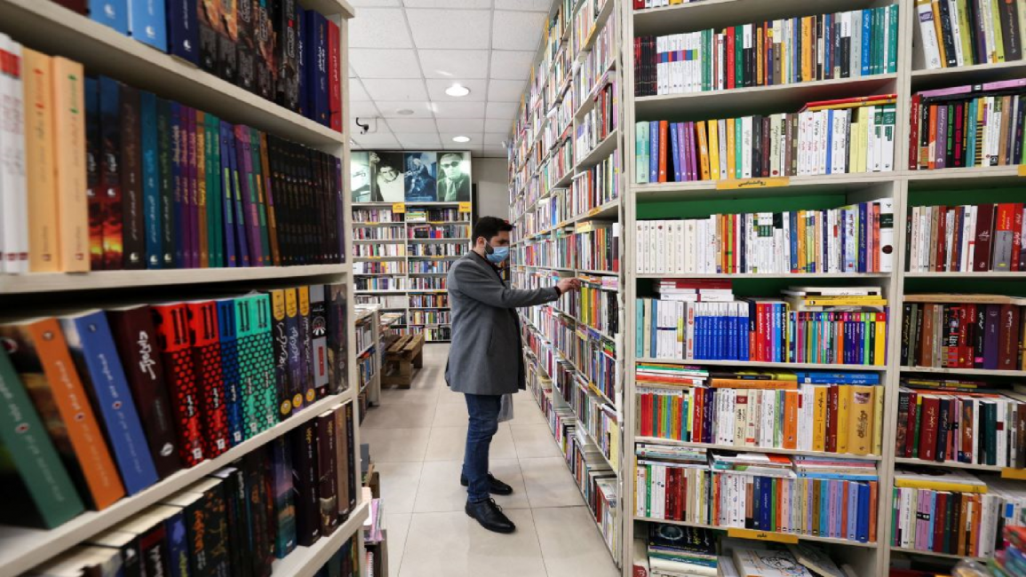 An Iranian man browses books at a library in Tehran