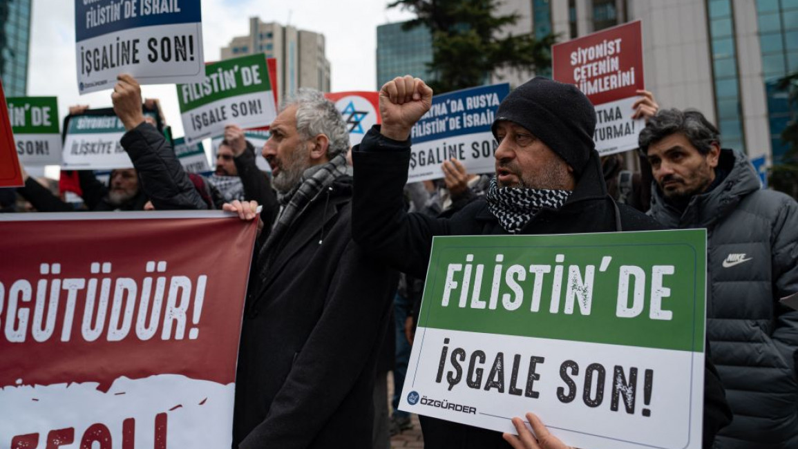 Protesters held up signs saying "end the occupation of Palestine" [Getty]
