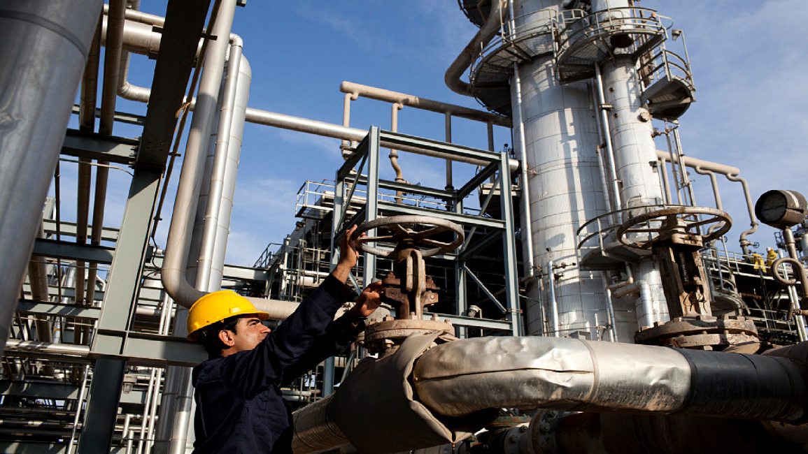 A worker monitors pressure levels at the Kar Refinery in Erbil, Iraq