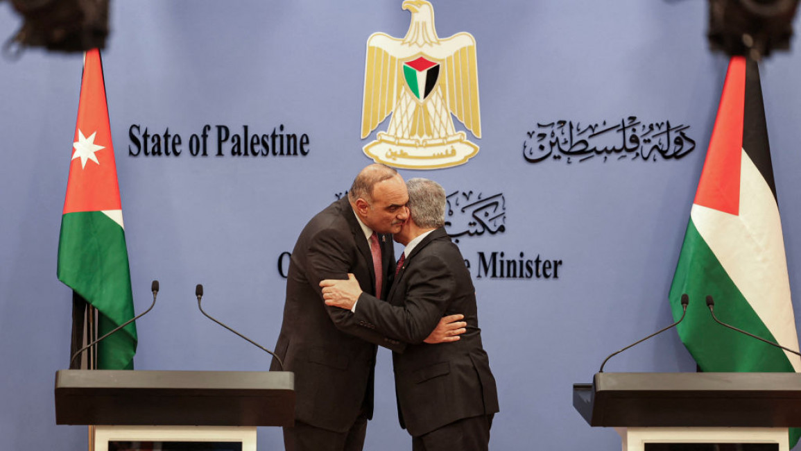 Bisher al-Khasawneh (left), Jordan's premier and his Palestinian counterpart, Muhammad Shtayyeh (right), embrace