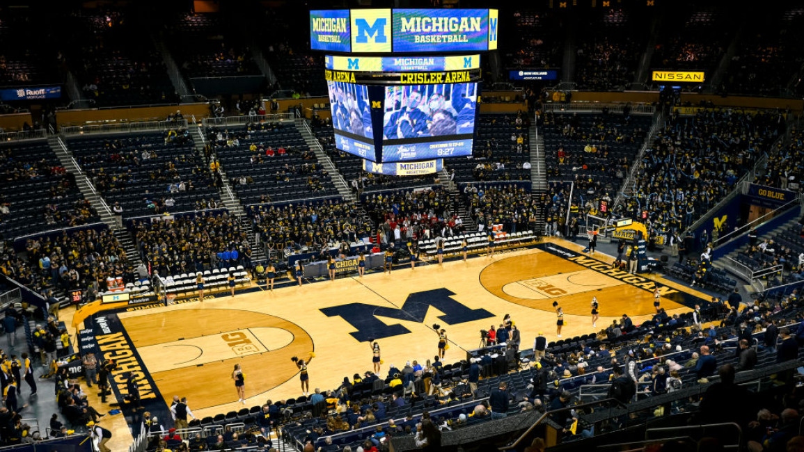 A basketball arena at a Michigan Wolverine's match.