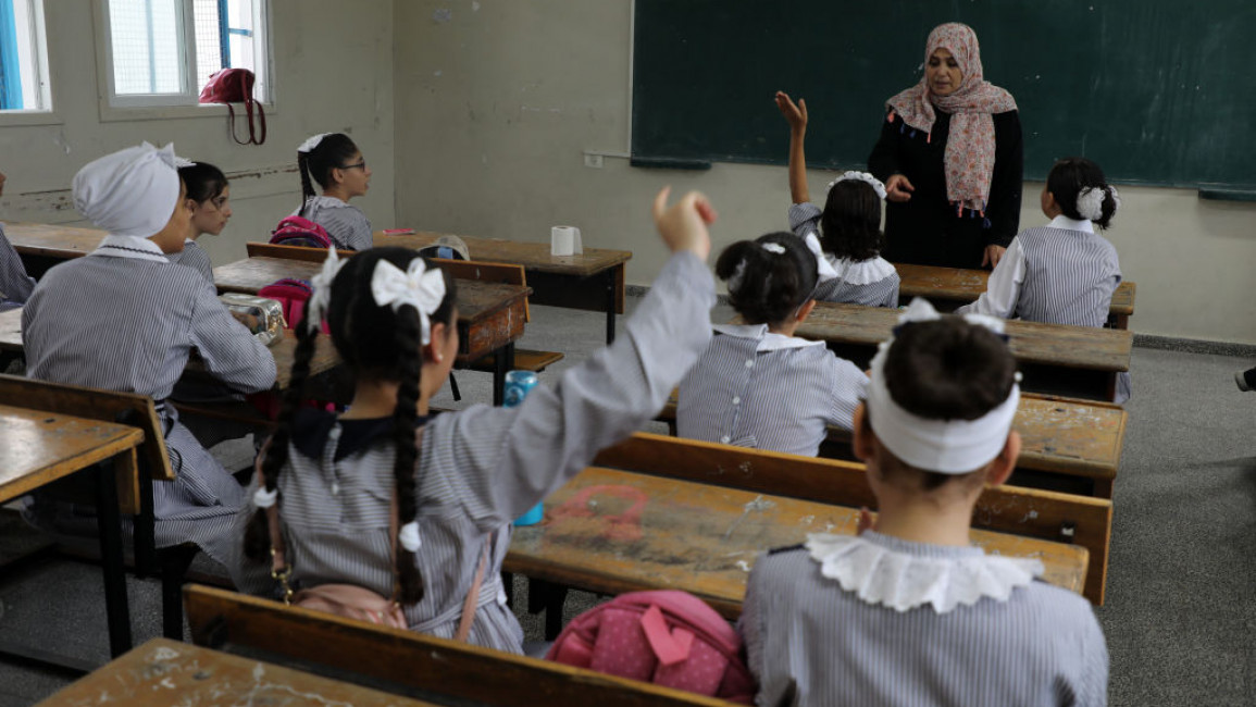 Students and a teacher in a classroom at an UNRWA school in Gaza.
