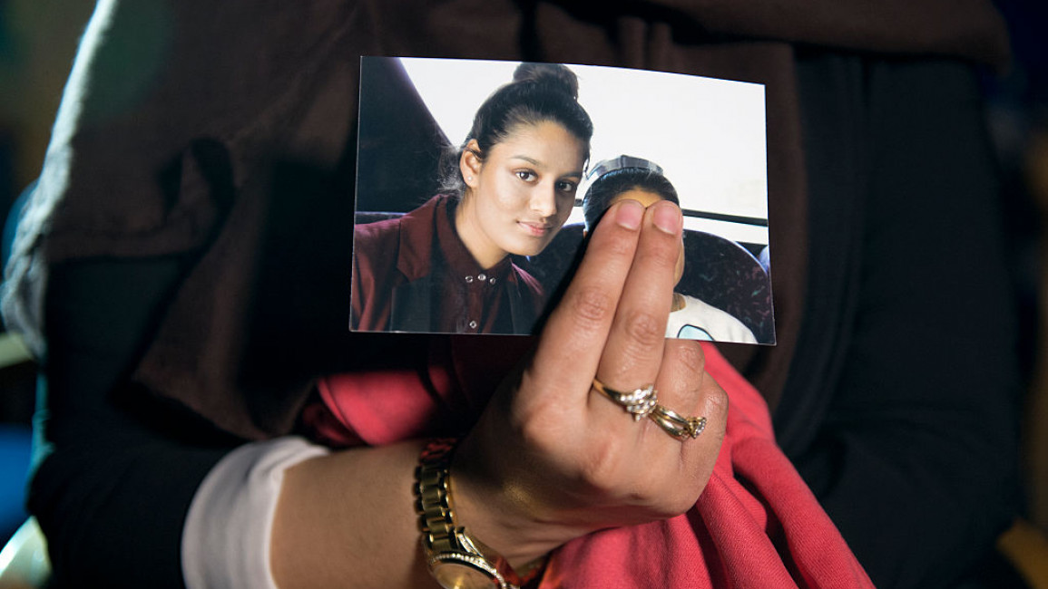 Renu Begum, eldest sister of Shamima Begum, then 15, holds her sister's photo as she is interviewed by the media at New Scotland Yard, as the relatives of three missing schoolgirls believed to have fled to Syria to join Islamic State pleaded for them to return home [Getty Images]