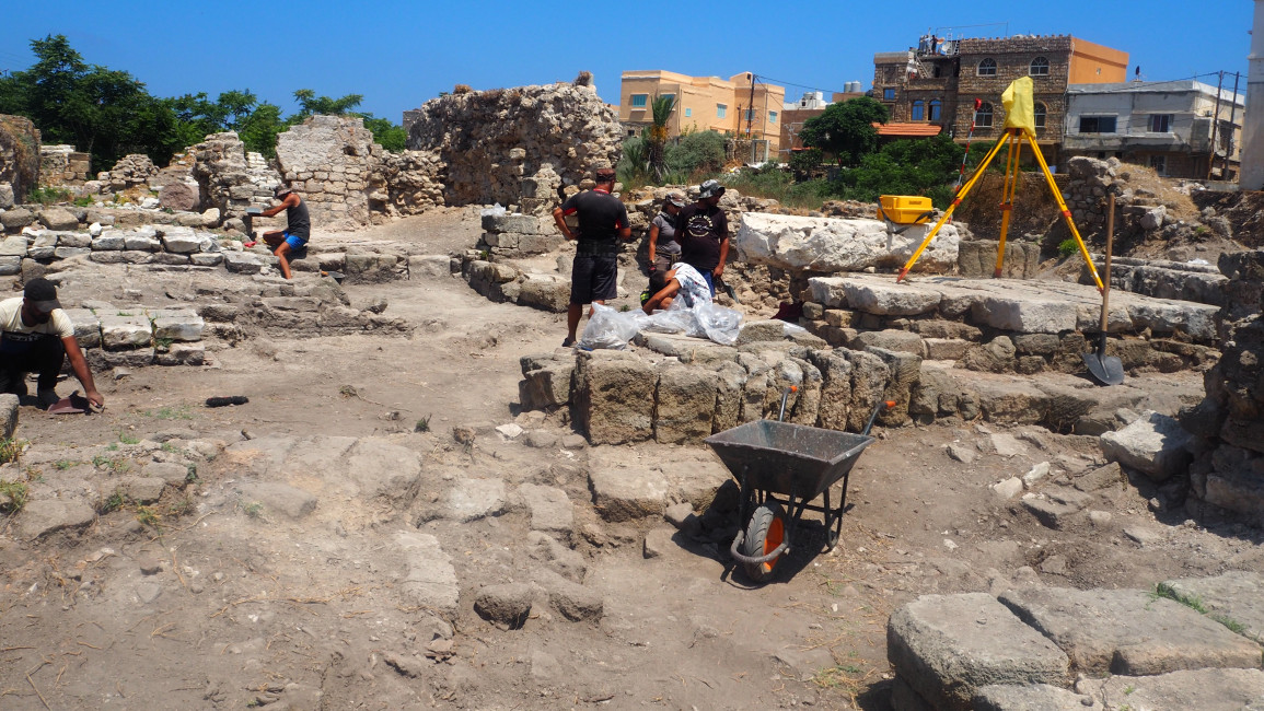 Workers excavate a site in southern Lebanon