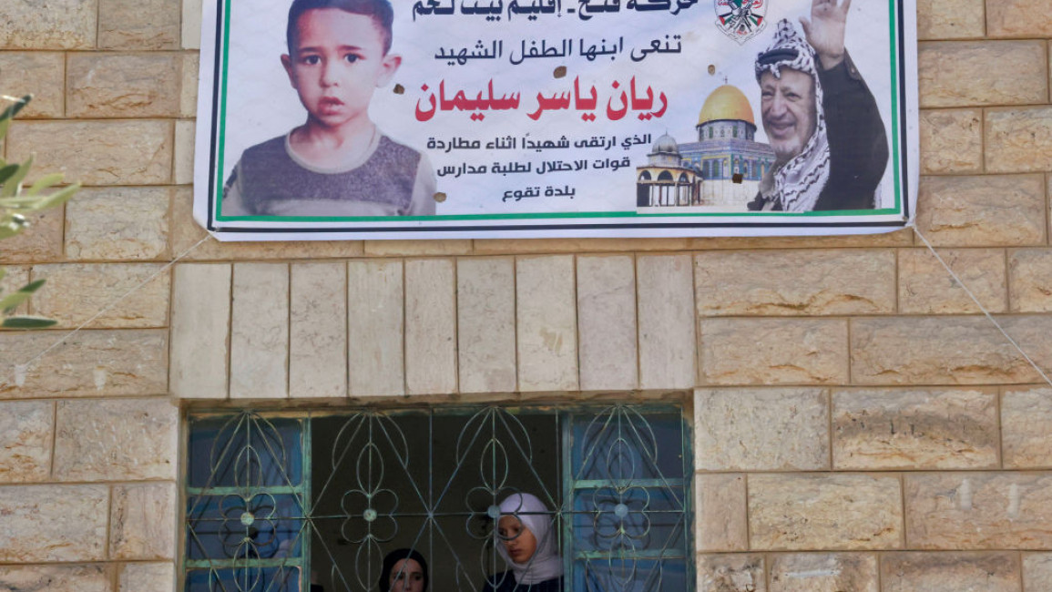 Palestinians mourned Rayan Suleiman (in poster on left) after he died following a chase by Israeli army soldiers [Getty]