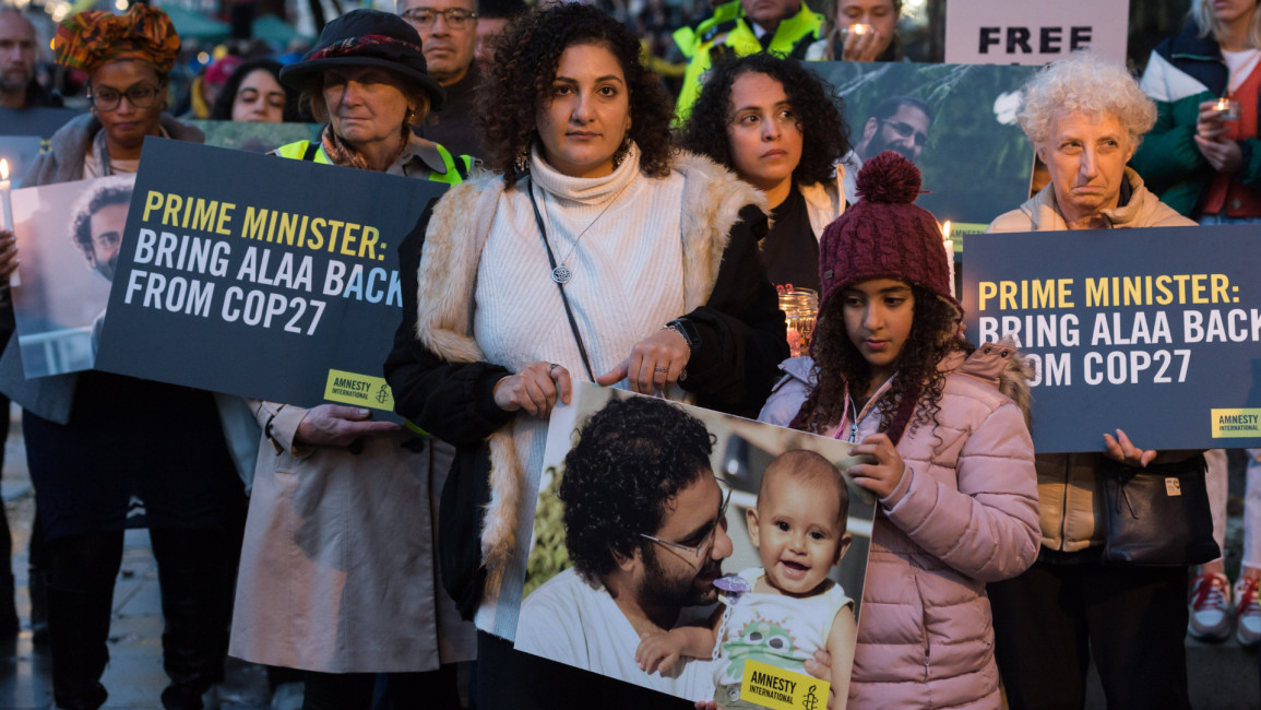 Mona Seif (CL), sister of the jailed British-Egyptian human rights activist Alaa Abd el-Fattah, is joined by supporters during a candlelight vigil outside Downing Street to demonstrate concern for her brother who is beginning a complete hunger strike as world leaders arrive for COP27 climate summit in Sharm el-Sheikh in London, United Kingdom