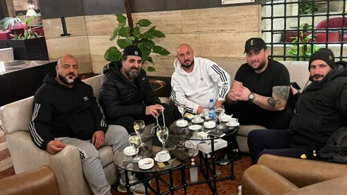 Wasim al-Assad, Nooh Zeitar and others pose together in an apparent hotel lobby. [Facebook] 