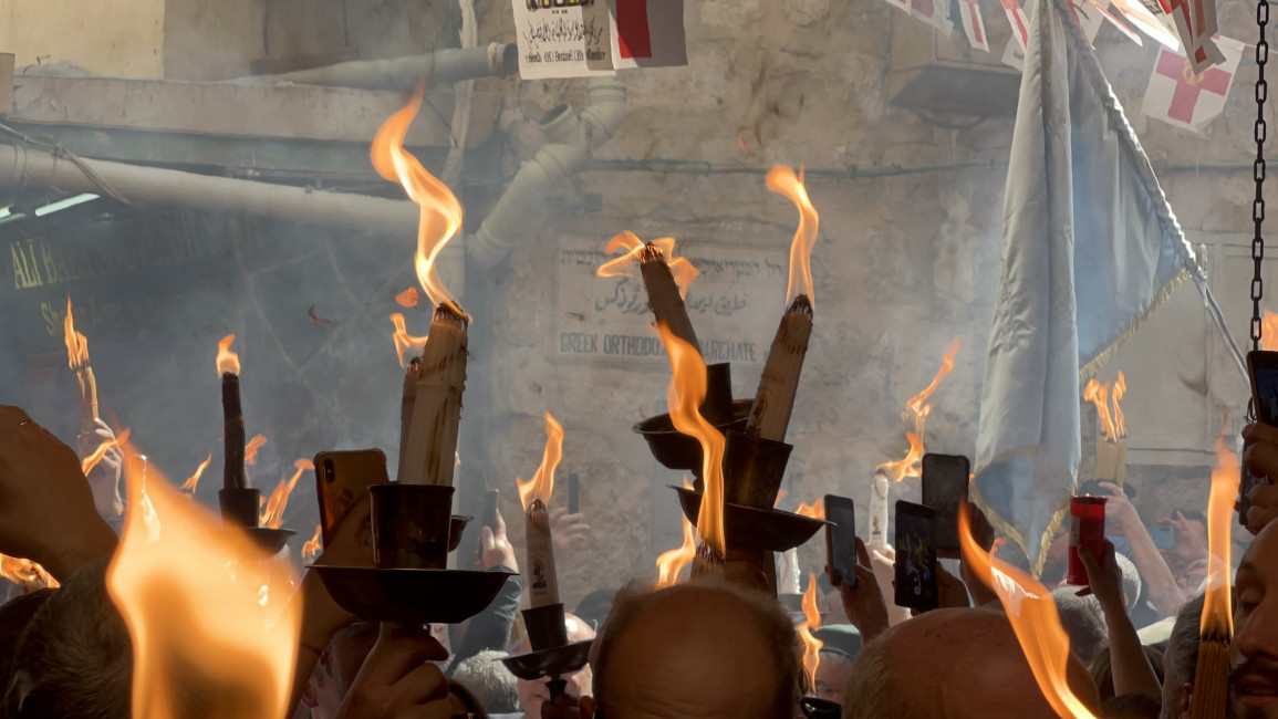Christians celebrate the "miracle" of "Holy Fire" in the Old City of Jerusalem on 15 April 2023. Ibrahim Husseini/TNA