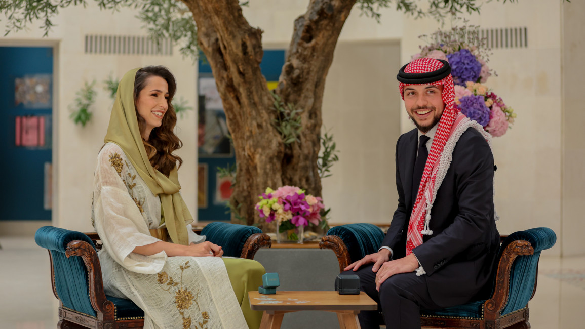 Crown Prince al-Hussein ibn Abdullah of Jordan sits with his bride, Rajwa al-Seif.