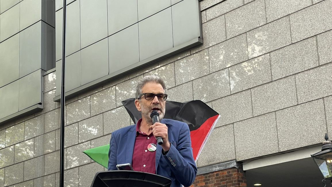 Palestine Solidarity Campaign director Ben Jamal addresses protesters at a rally outside Israel's London embassy on 5 July 2023