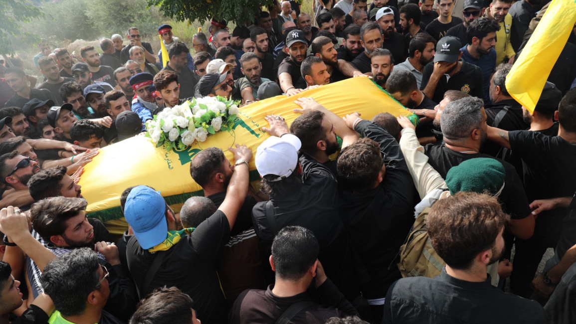 Mourners gather at a funeral for a Hezbollah member killed in an Israeli airstrike on 10 October. [William Christou - TNA]