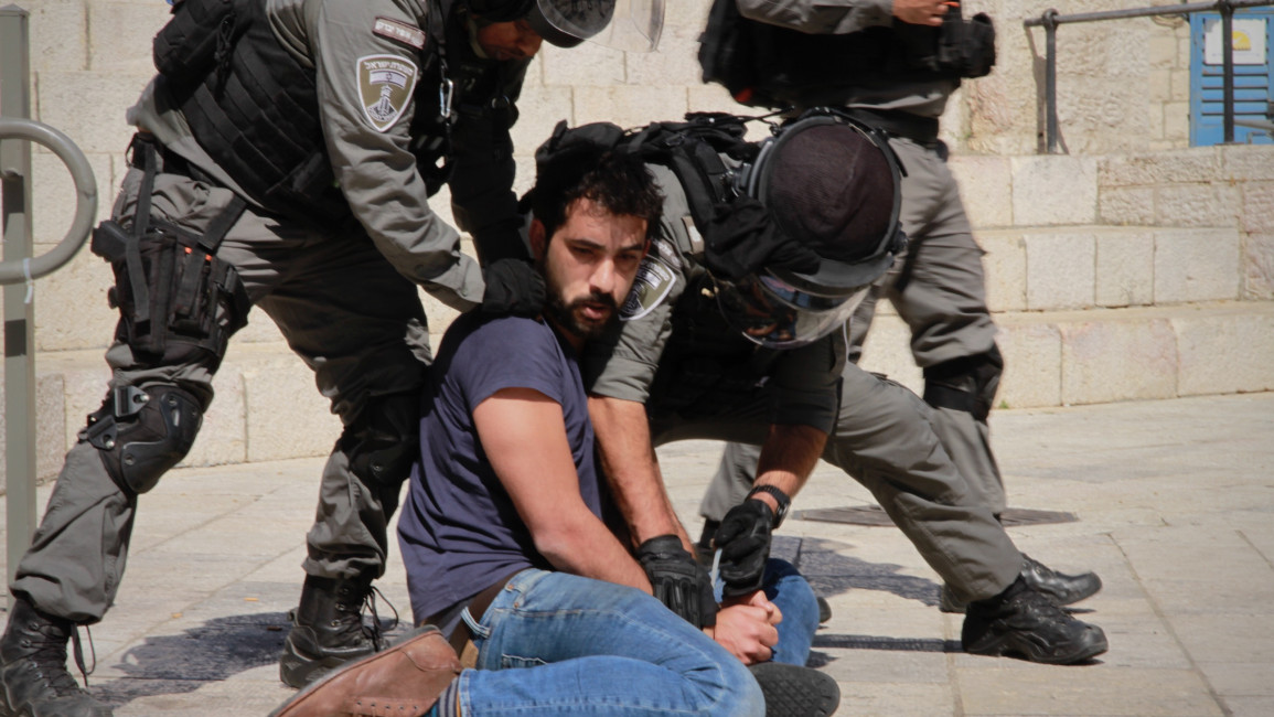 Israeli soldiers subdue a young Palestinian man in occupied East Jerusalem. Ibrahim Husseini/TNA