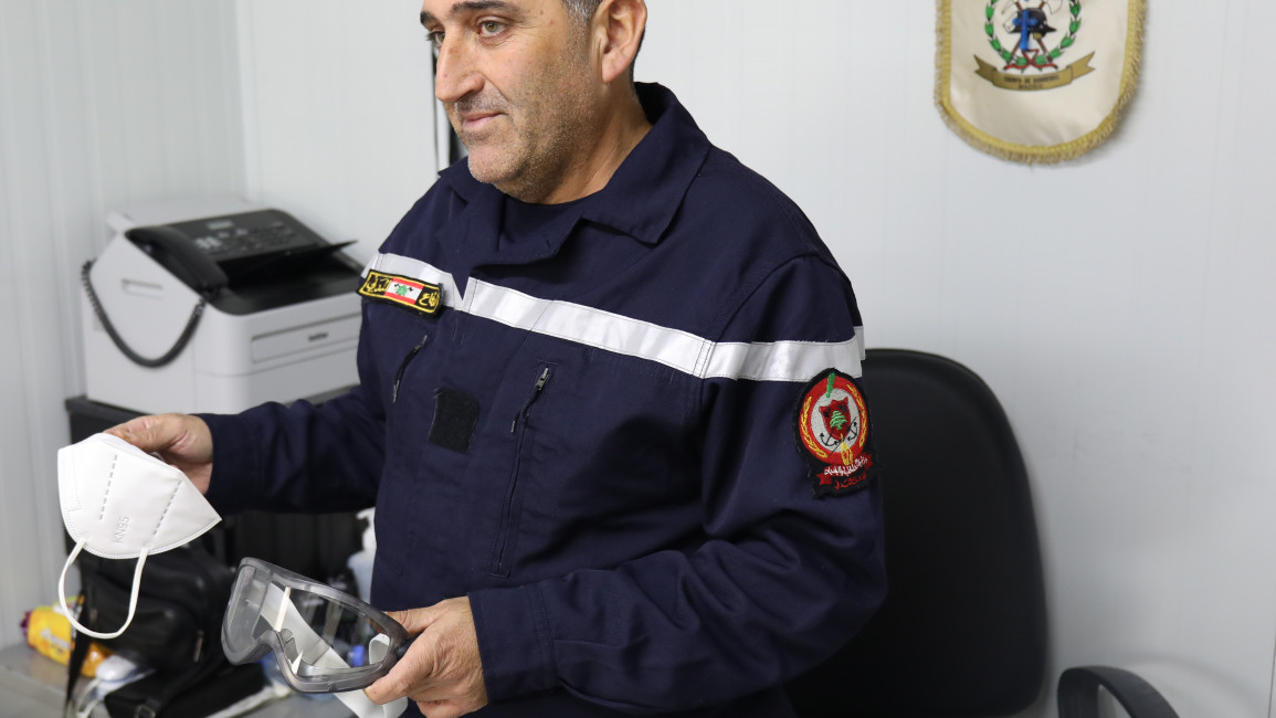 Anis Abla, the head of the firefighting center in the southern Lebanese city of Marjayoun, holds up the equipment firefighters previously used to combat white phosphorus fires. [William Christou- TNA].