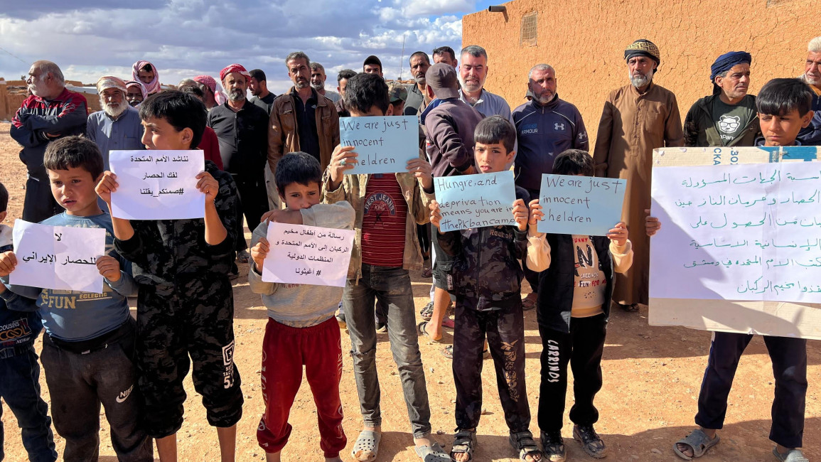Children in al-Rukban, an IDP camp in the no-man's-land between Syria and Jordan, appeal to the international community to end the siege on the camp. (Provided by a camp resident)