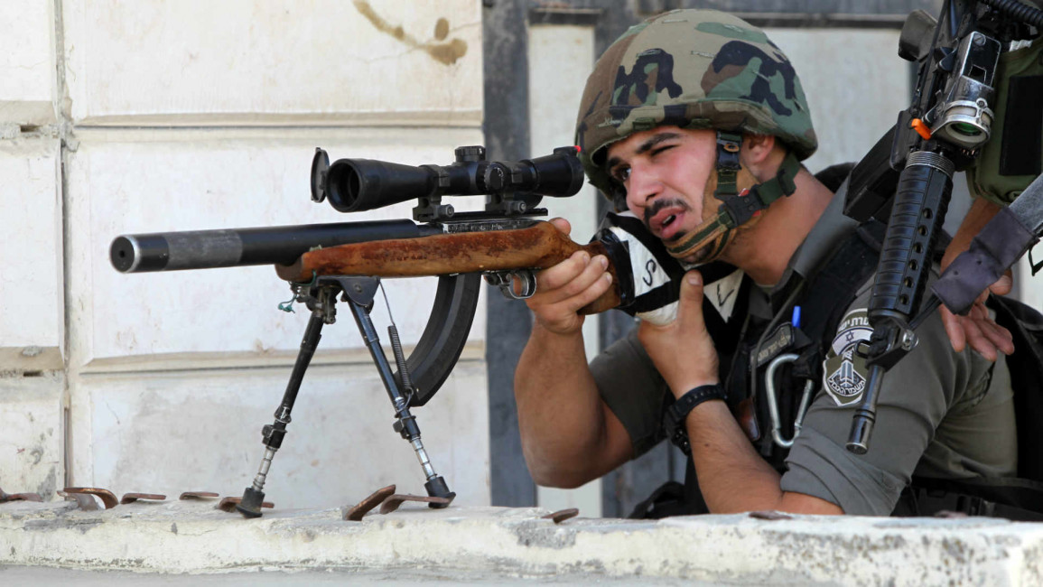 Israeli border guard aims his sniper