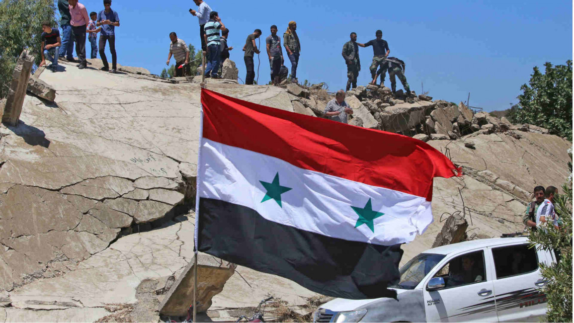 Syrian rebels atop destroyed building