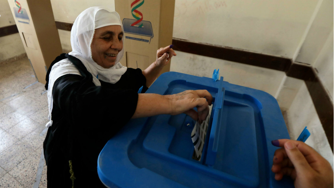 An Iraqi Kurdish woman casts her ballot in Irbil