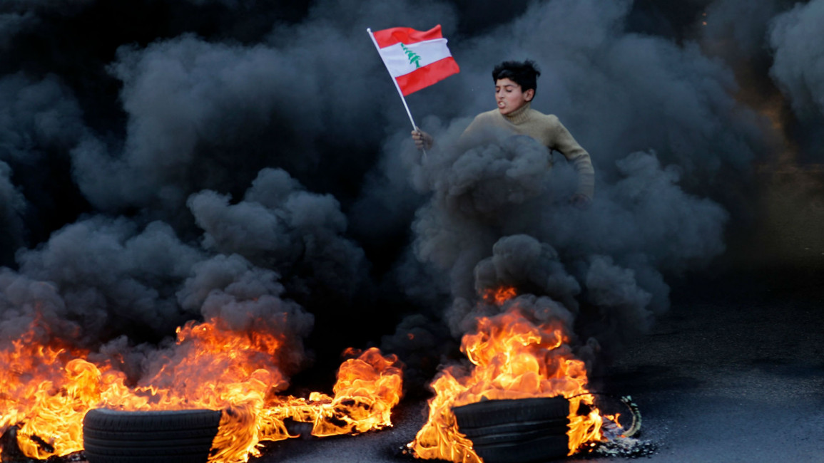 Lebanese boy running through smoke at protest [Getty]