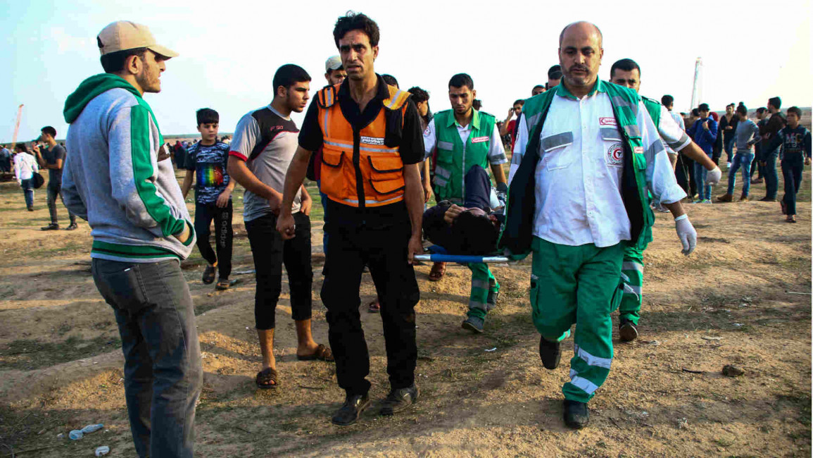 Medical crew carrying a Palestinian protester