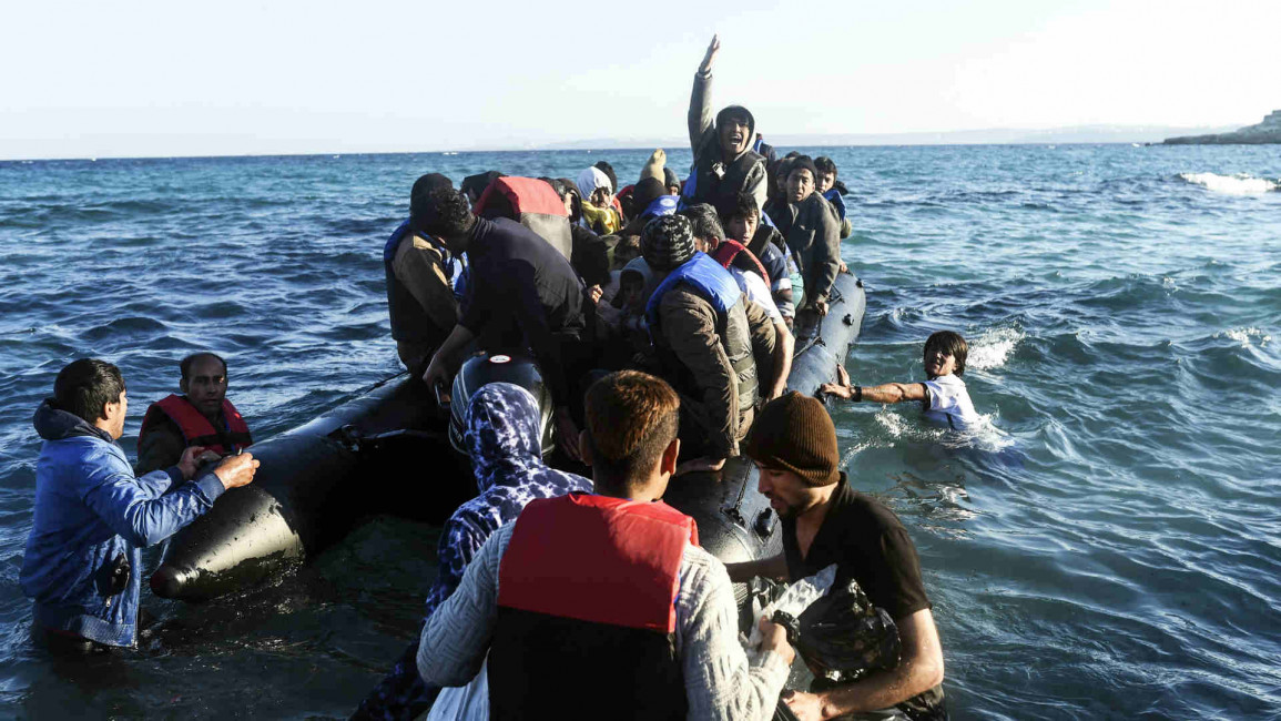 Migrants board a dinghy near Turkey's Izmir province
