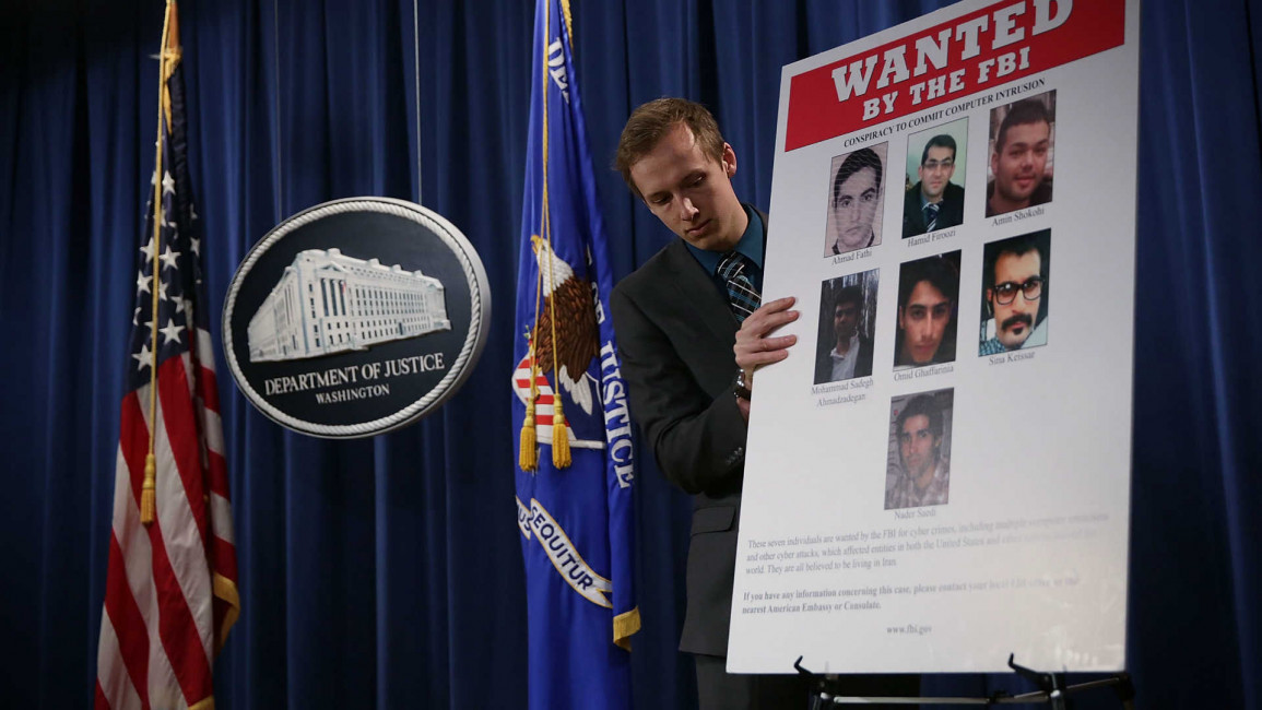 Department of Justice worker puts up wanted sign