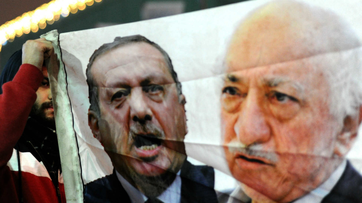 Protester holds banner of Erdogan and Gulen