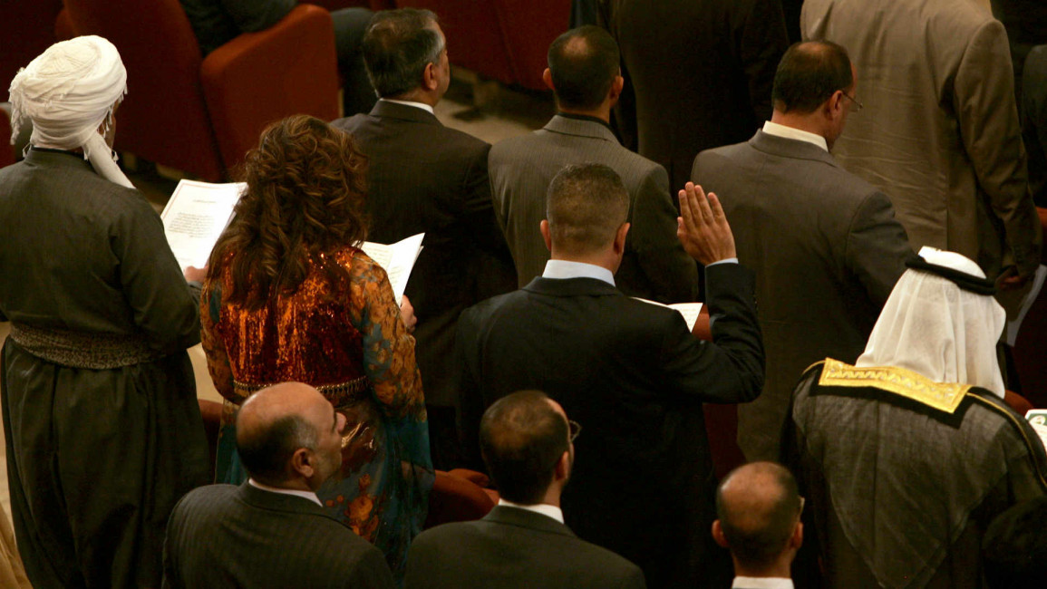 Iraqi lawmakers take an oath as parliament opens