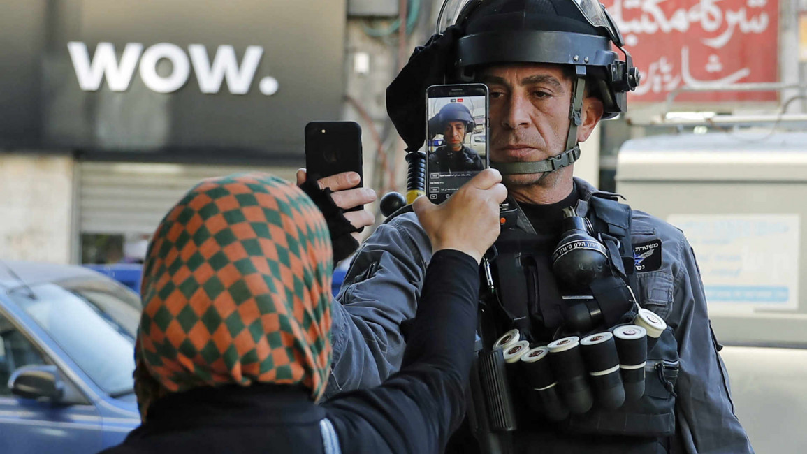 Palestinian woman cellphone Israeli soldier AFP