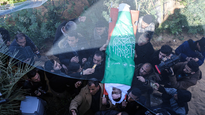 Palestinians carry the dead body of a Palestinian child killed by Israeli fire in Gaza City [Anadolu Agency/Getty]