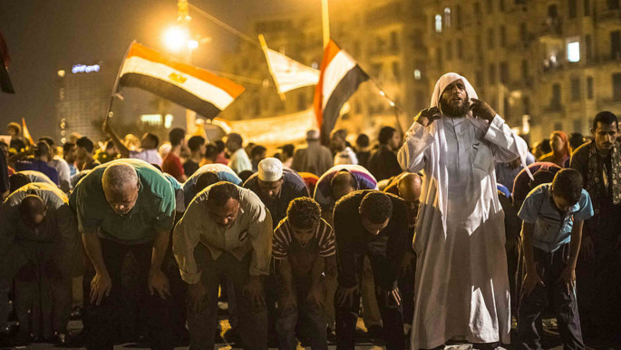 Egyptians protesters are lead in prayer during a protest against presidential candidate Ahmed Shafiq in Tahrir Square 2012