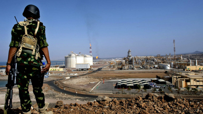 Yemeni soldier stands guard at the newly built liquefied natural gas (LNG) plant on the Gulf of Aden