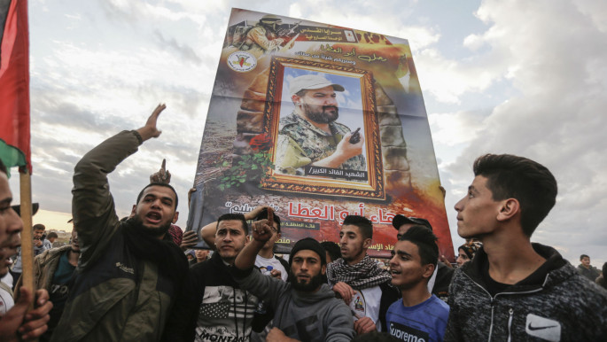 Demonstrators carry a photograph of fallen PIJ commander, Baha Abu al-Ata
